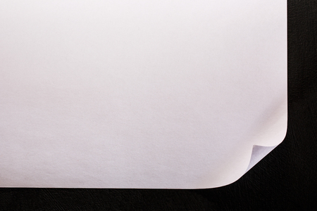 Blank sheet of paper on black backgroundの写真素材