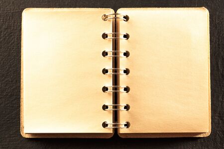 Blank open notebook on the black backgroundの写真素材