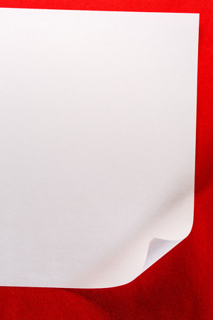 Blank sheet of paper on red backgroundの写真素材