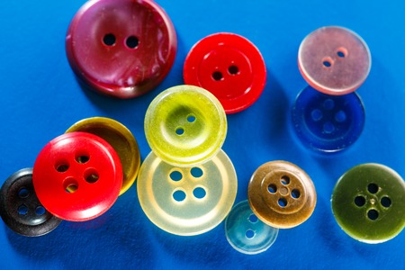 Colourful buttons on blue background in closeupの写真素材