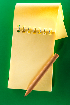 Blank open notebook on the green backgroundの写真素材