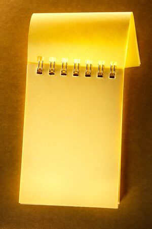 Blank open notebook on the brown backgroundの写真素材