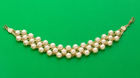 Wristband with golden chain and white beadsの写真素材
