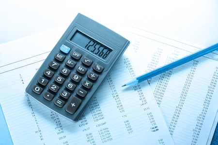 Operating budget, calculator and pencil in closeupの写真素材