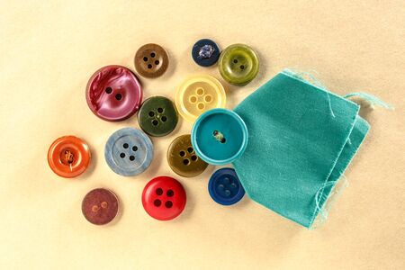 Colourful buttons on paper background in closeup