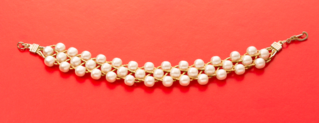 Wristband with golden chain and white beadsの写真素材
