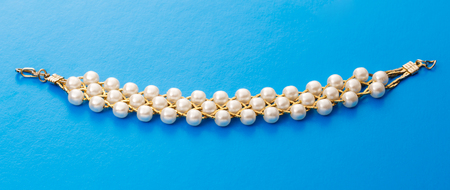 Wristband with golden chain and white beadsの写真素材