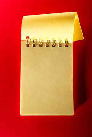 Blank open notebook on the red backgroundの写真素材