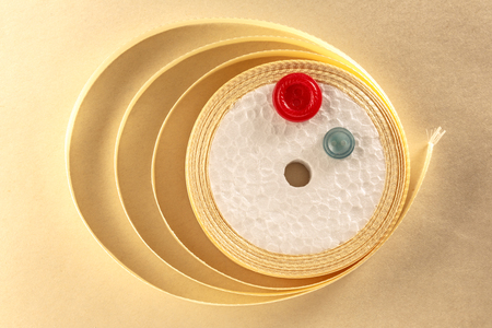 Colourful buttons and ribbon roll in closeupの写真素材