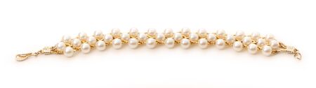 Wristband with golden chain and white beadsの写真素材