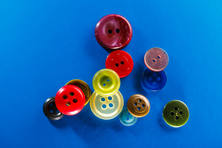 Colourful buttons on blue background in closeupの写真素材