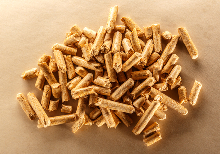 Wooden pellets on paper background in closeupの写真素材