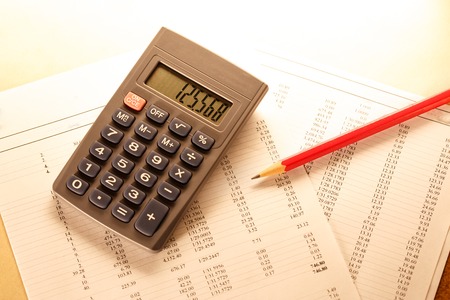 Operating budget, calculator and pencil in closeupの写真素材