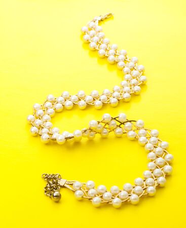 Necklace with golden chain and white beadsの写真素材