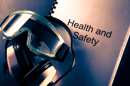 Health and safety document with earphones and gogglesの写真素材