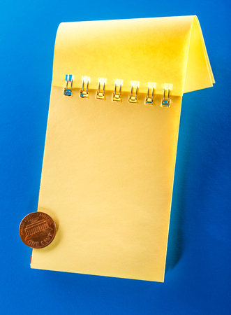 Blank open notebook with cent on the blue backgroundの写真素材