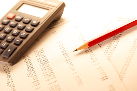 Operating budget, calculator and pencil in closeupの写真素材
