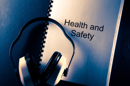 Health and safety document with earphones in toningの写真素材