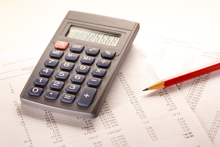 Operating budget, calculator and pencil in closeupの写真素材