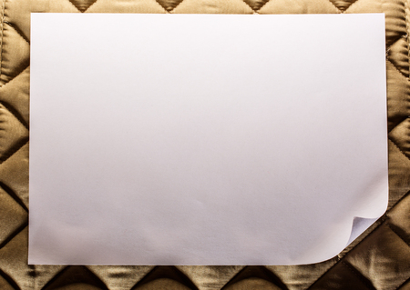 Blank sheet of paper on textile backgroundの写真素材