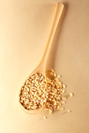 Pearl barley and wooden spoon in closeupの写真素材