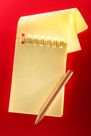 Blank open notebook on the red backgroundの写真素材