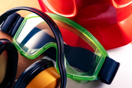 Helmet, earphones, goggles and blank sheet of paperの写真素材