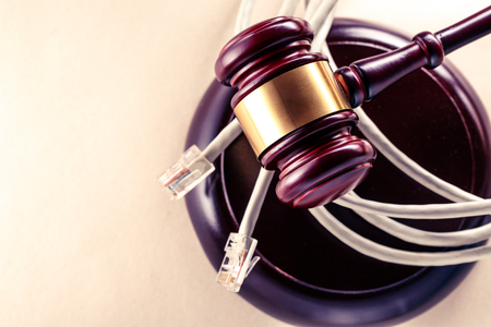 Computer cable and wooden gavel in toningの写真素材