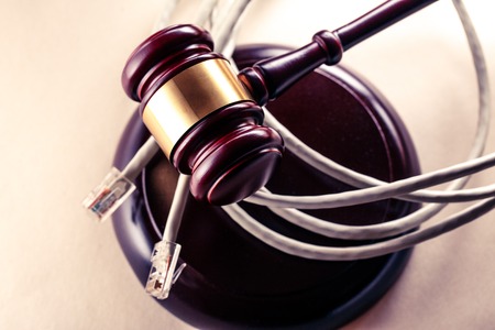 Computer cable and wooden gavel in toningの写真素材