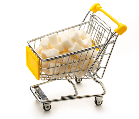 Supermarket pushcart with pile of white sugar cubesの写真素材