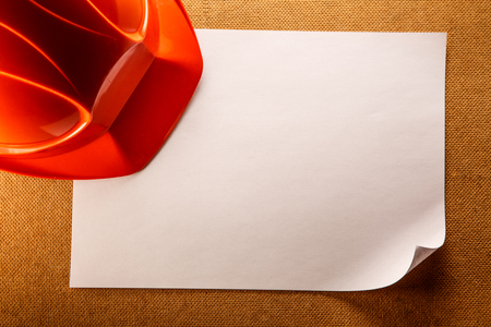 Red helmet and blank sheet of paperの写真素材