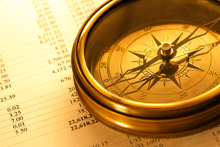 Operating budget and vintage compass in closeupの写真素材