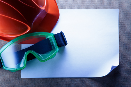 Helmet, goggles and blank sheet of paperの写真素材