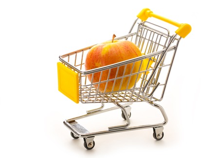 One fresh apple in small supermarket pushcart closeupの写真素材
