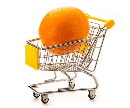 One fresh orange in small supermarket pushcart closeupの写真素材