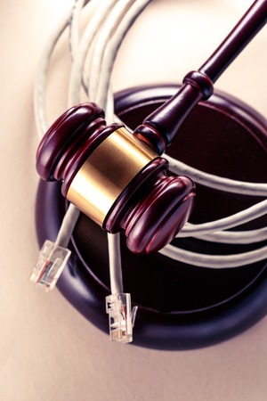 Computer cable and wooden gavel in toningの写真素材