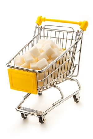 Supermarket pushcart with pile of white sugar cubesの写真素材