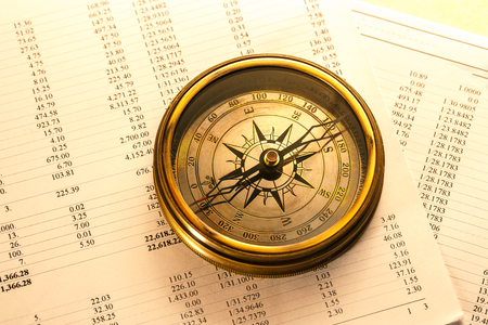 Operating budget and vintage compass in closeupの写真素材