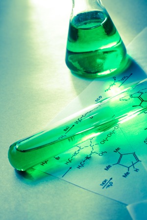 Chemical tubes with reaction formula in lightの写真素材