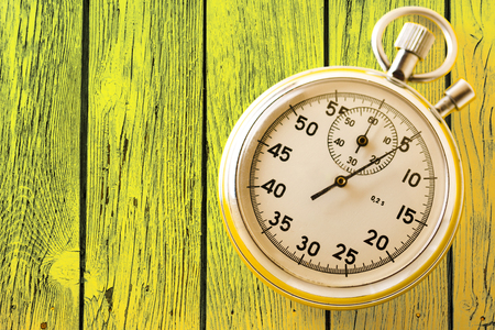 Stopwatch on yellow background in closeupの写真素材