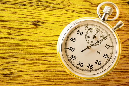 Stopwatch on yellow background in closeupの写真素材