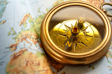 Metal compass on map background in closeupの写真素材
