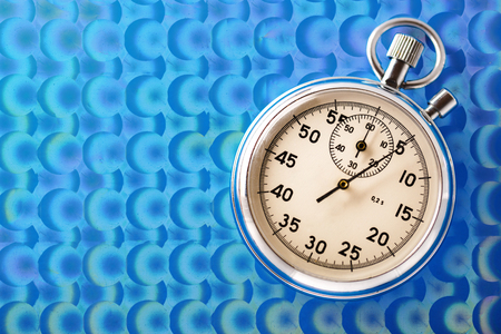 Stopwatch on blue background in closeupの写真素材