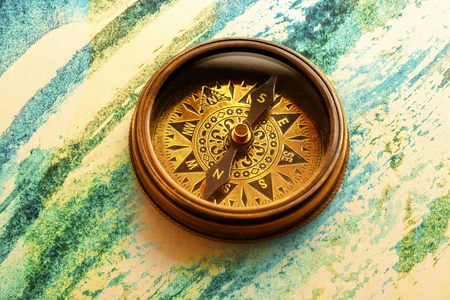 Vintage metal compass in toning light closeupの写真素材
