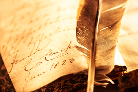Old book with feather pen in toningの写真素材