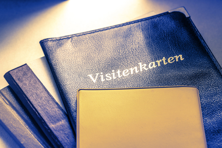 Business card holder with title in German and other notebooksの写真素材