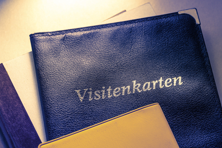 Business card holder with title in German and other notebooksの写真素材