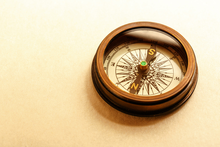 Vintage metal compass in toning light closeupの写真素材