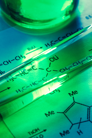 Chemical tubes with reaction formula in lightの写真素材