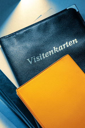 Business card holder with title in German and other notebooksの写真素材